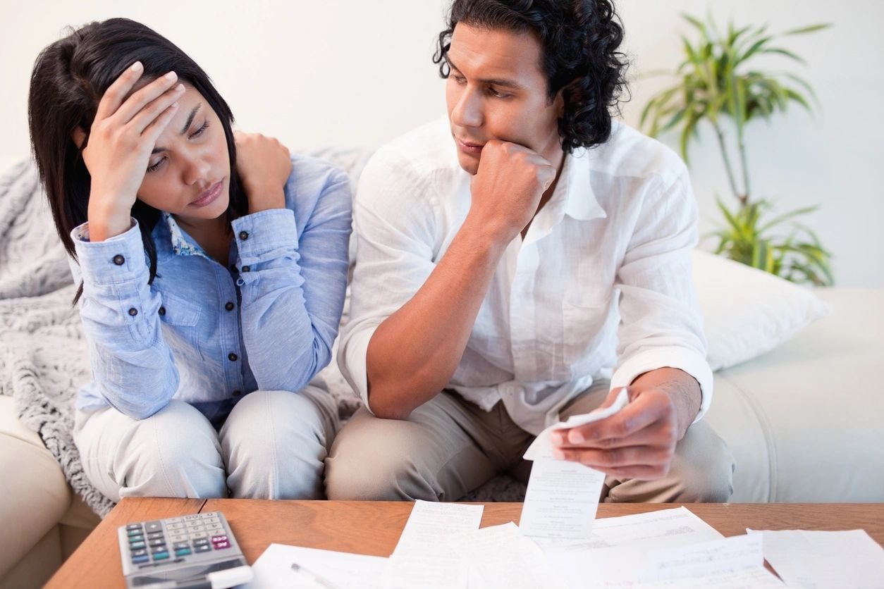 Couple reviewing financial documents at home